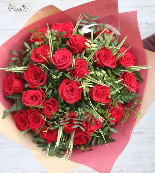 Round bouquet made of red roses and greens