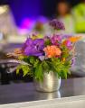 Small colorful summer flower arrangement in modern pot, with orchid 