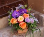 Romantic summer flower arrangement with roses, orchids
