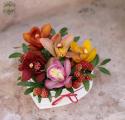 Small heart box with colorful orchids, berries