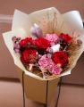 Red rose bouquet in bag with water, in theme of the color of the year Mocha Mousse