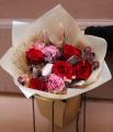 Red rose bouquet in bag with water, in theme of the color of the year Mocha Mousse
