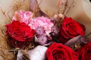 Red rose bouquet in bag with water, in theme of the color of the year Mocha Mousse
