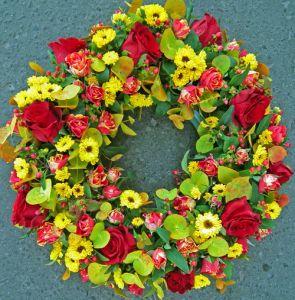 oasis wreath orange, red, yellow roses, mini roses, daisies, eucalypt (45cm)