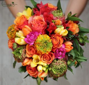 Bridal bouquet with orange spring flowers (freesia, tulip, rose, alstromeria, buttercup)