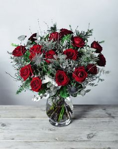 15 red roses with winter greenery, and vase