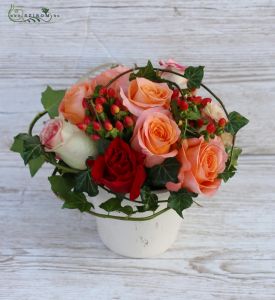Autumn style centerpiece with red and orange roses, hypericum berries
