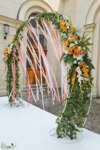 round wedding gate with ribbons and white-orange flower arrangement (rose, dahlia, gladiolus)