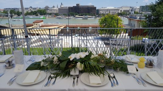 Wedding centerpiece, Bazaar Eclectica Café and Restaurant Budapest (phalaenopsis orchid, monstera leaf, palm leaf, white, green, gold)