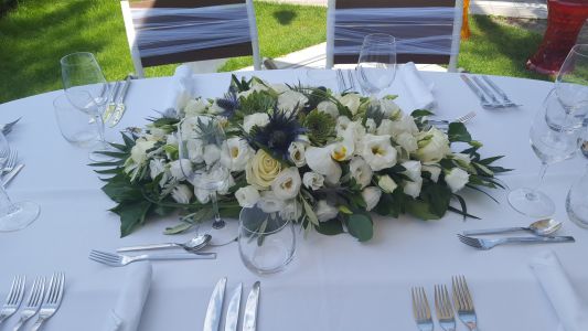 Main table centerpiece, Emile Étterem Budapest (lisianthus, phalaenopsis orchid, eryngium, stonecrop, white, blue)