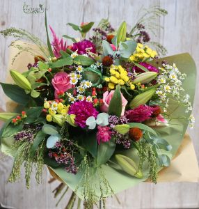 Seasonal meadow flowers in bouquet with frog