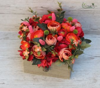 Blazing red silk flowers in wooden drawer