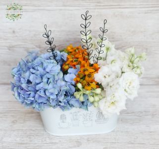 Tin pot with hydrangeas and summer flowers