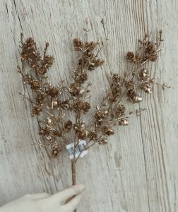 Bronze-colored artificial branch with cones