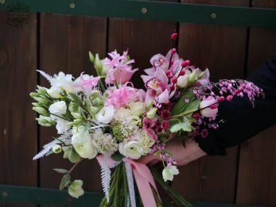 Pale pink crescent bridal bouquet (pale pink, white, orchid, bush rose, lisianthus, David Austin rose, tulip, freesia, buttercup, scabiosa)
