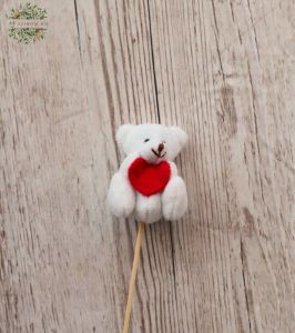 white teddybear with a heart on a stick