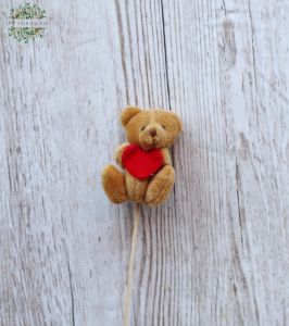 brown teddybear with a heart on a stick