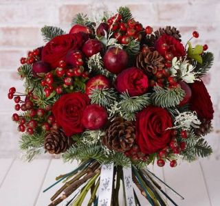 Bouquet with red roses, berries and pine cones