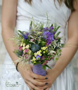 Bridal bouquet with meadow flowers (veronika, matricaria, eryngium, sedum, blue)