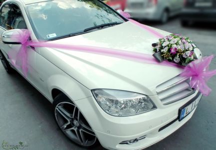 round car flower arrangement with spray roses and orchids with organsa (purple, pink)