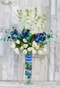 Tall vase centerpiece with tulips, blue orchids, stockflowers, wedding