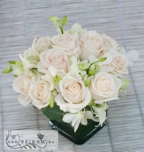 Centerpiece with cream roses and dendrobiums, wedding