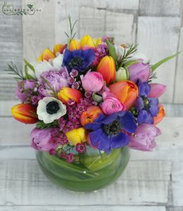 Centerpiece with spring flowers in glass ball (purple, orange, tulip, anemone, buttercup), wedding