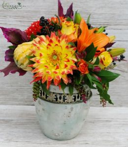 Autumn flower arrangement in rustic ceramic pot