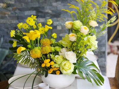 Large wedding event table decoration or centerpiece, crescent-shaped (yellow, calla, rose, leucospermum, lisianthus, English rose)