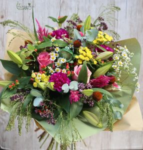 Seasonal meadow flowers in bouquet with frog