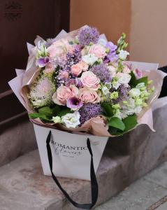 Trendy bag bouquet with pink roses and purple flowers