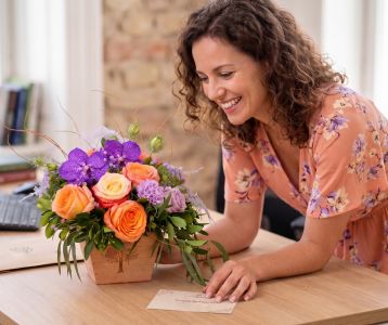 Romantic summer flower arrangement with roses, orchids