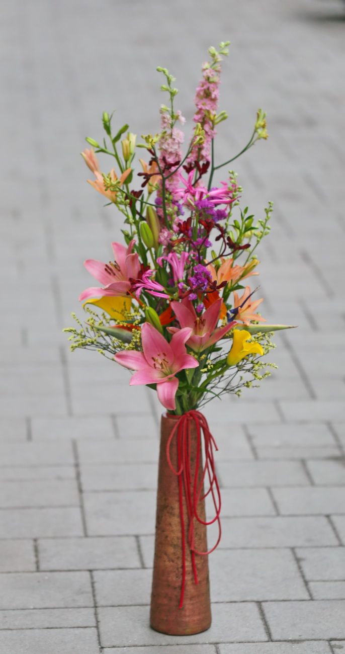 flower delivery Budapest - long bright colored bouquet in a long terracotta vase