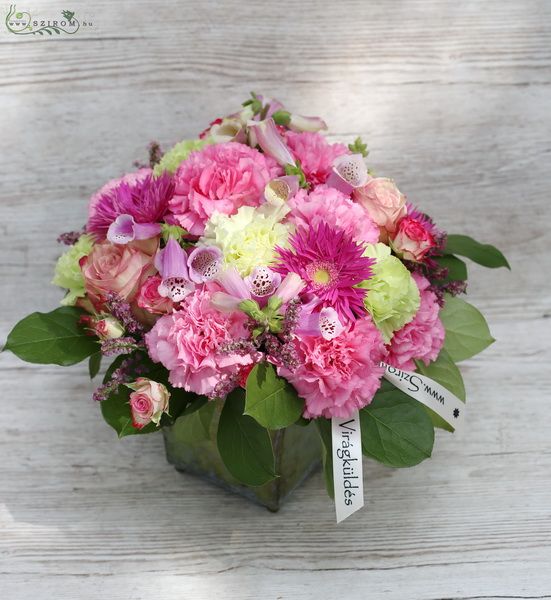 Glass cube, with carnations, pink flowers and seasonal summer flowers