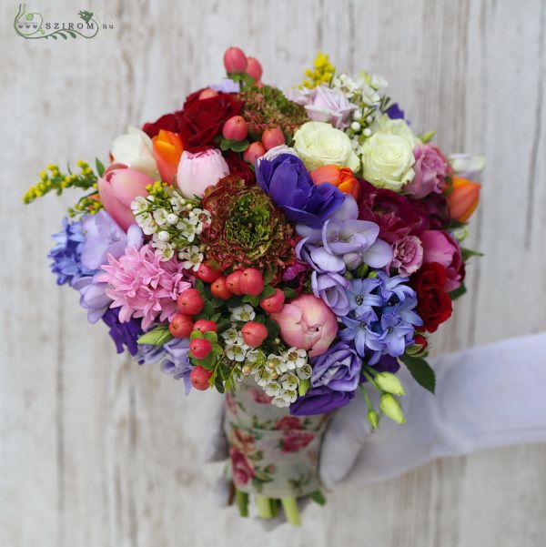 Bridal bouquet with spring flowers (tulip, ranunculus, hyacinth, anemone, hypericum, pink, purple, orange) spring