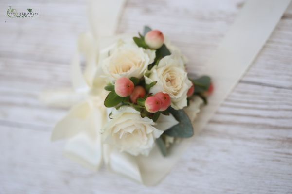 wrist corsage made of creme spray roses and hypericum