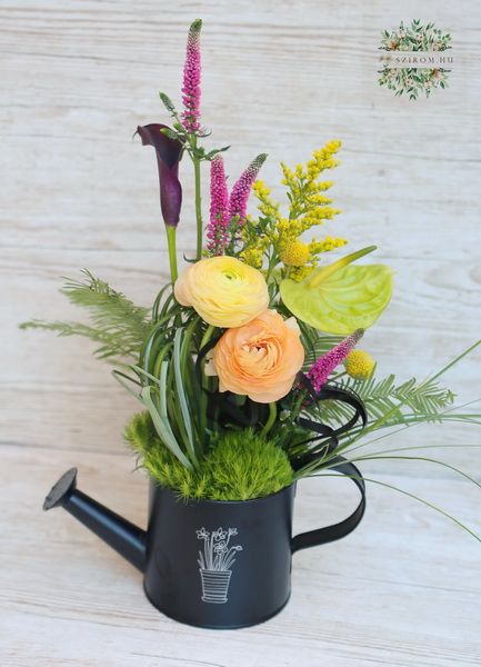 Trendy watering can with cala lilie, anthurium