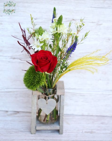 Vase with heart, red rose and colorful wildflowers