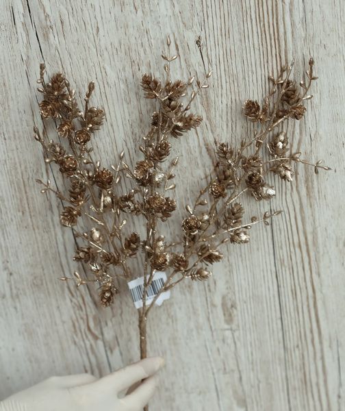Bronze-colored artificial branch with cones