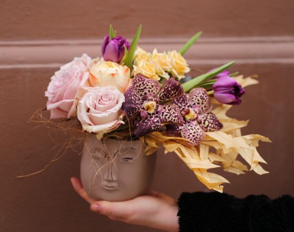 Head pot with windblown flower hair, in the theme of color of the year Mocha Mousse