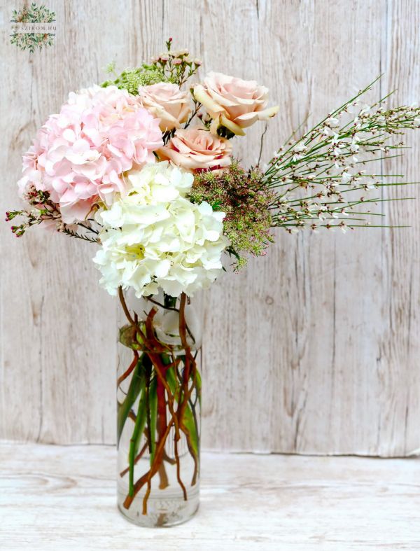 Modern pastel bouquet with roses, hydrangeas, in cylinder vase