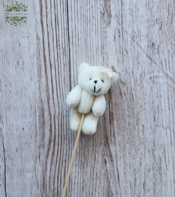 weisser Teddybear an einer Stabe mit einem Bogen