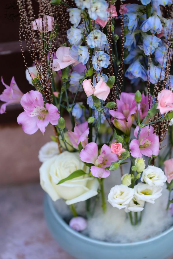Airy flower bowl with delphinium, lisianthus, pearl catkin, snails