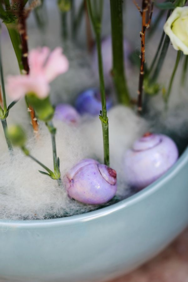 Airy flower bowl with delphinium, lisianthus, pearl catkin, snails