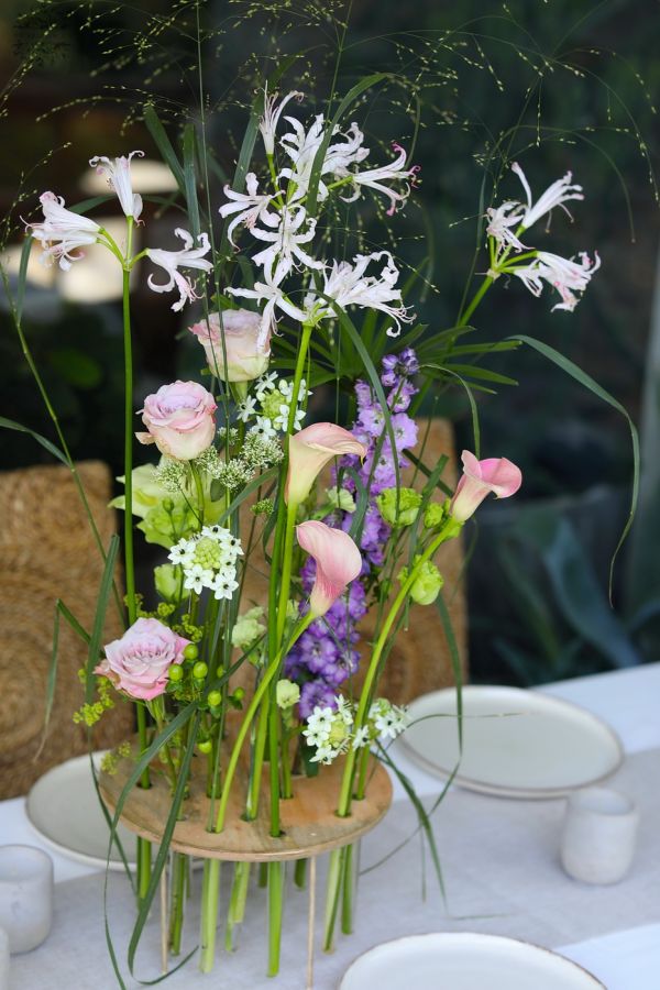 Modern airy wedding, event centerpiece, base with vials (purple, green, calla, rose, nerine, delphinium, lisianthus)