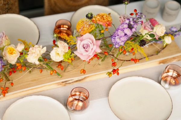 Modernes Hochzeitsdekor auf Holztisch (Lavendelviolett, Orange, Pastellgelb, Englische Rose, Rittersporn, Leucospermum)