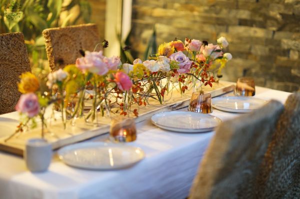 Modern wedding event centerpiece on wooden table (rosehip, lavender purple, orange, pastel yellow, English rose, leucospermum)