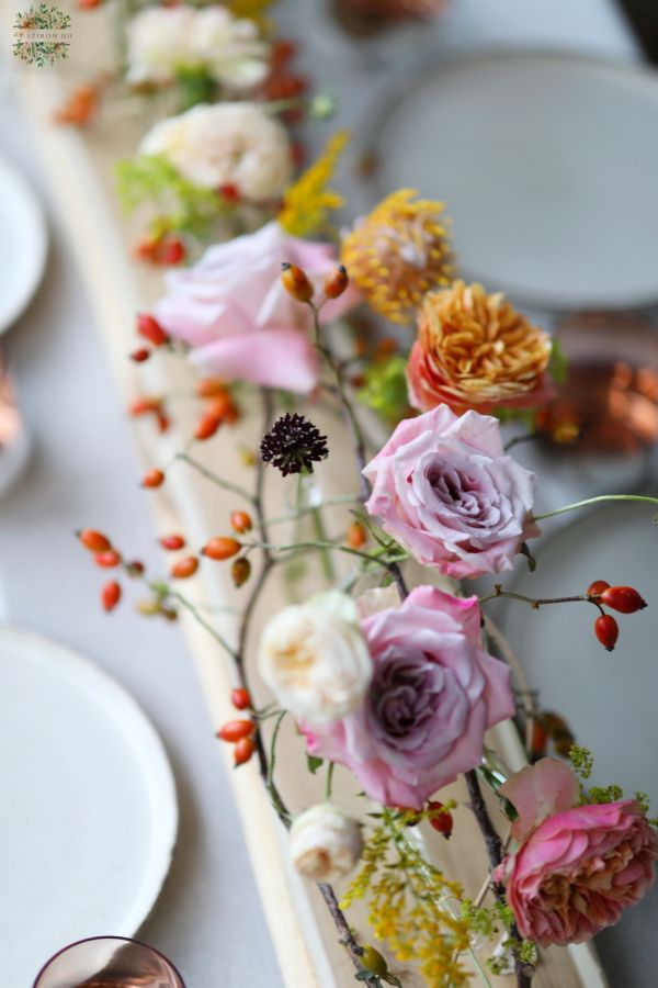 Modern wedding event centerpiece on wooden table (rosehip, lavender purple, orange, pastel yellow, English rose, leucospermum)