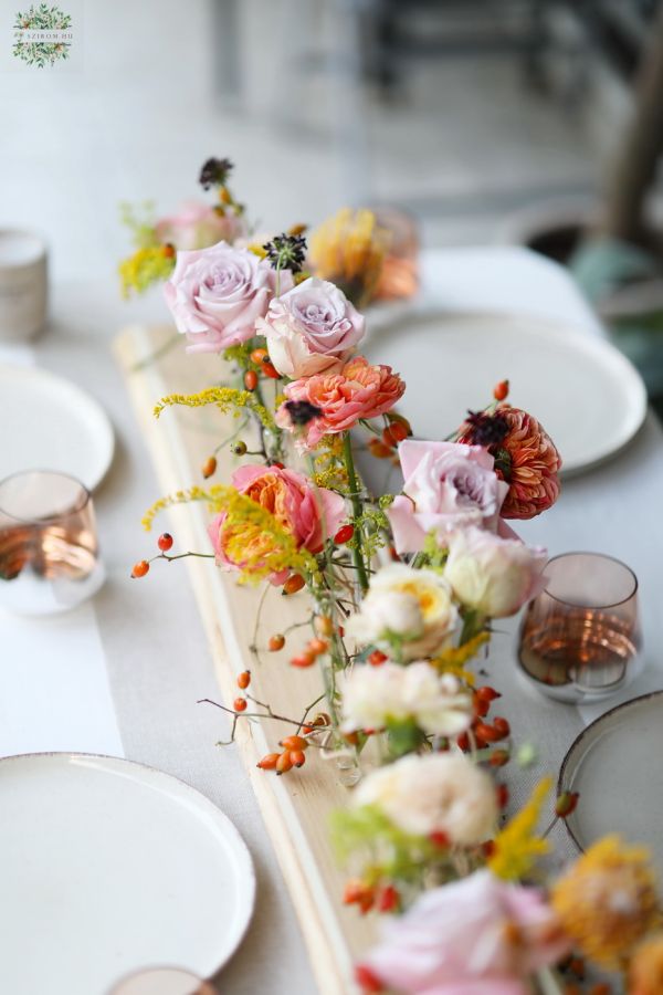 Modern wedding event centerpiece on wooden table (rosehip, lavender purple, orange, pastel yellow, English rose, leucospermum)