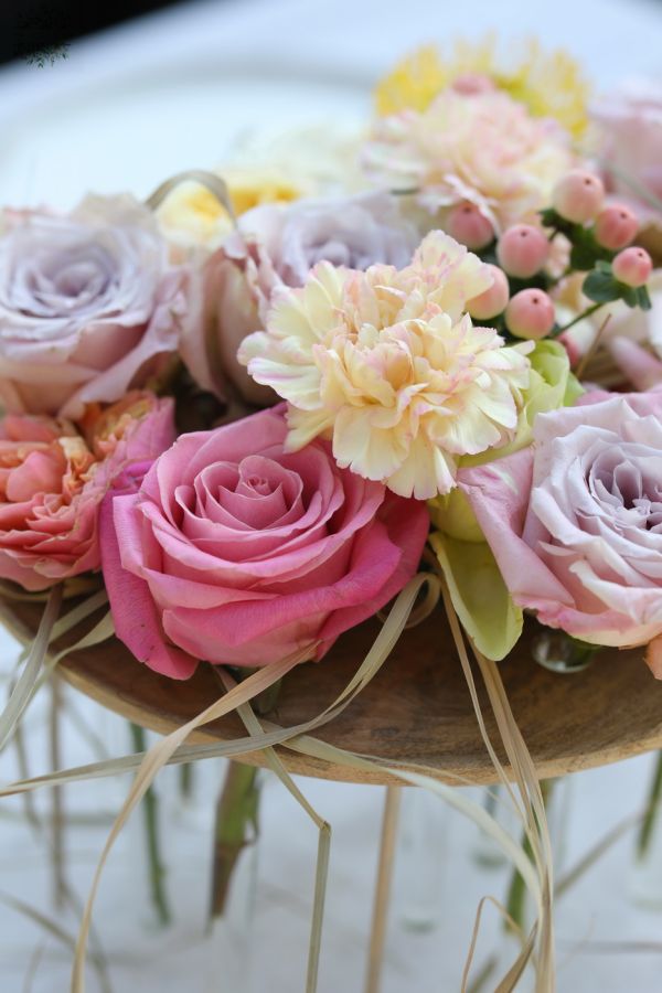 Modern wedding and event table decoration with pastel roses (lavender purple, pink, light yellow, rose, English rose, carnation, leucospermum)